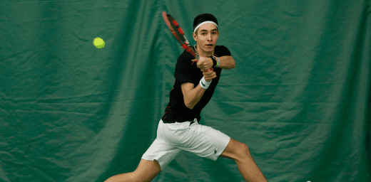 Image of young male player playing high performance tennis.