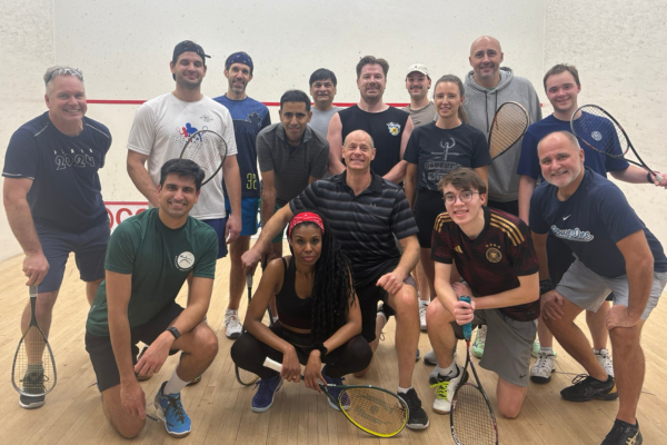 Image of a group of squash players on an indoor squash court at Mayfair Lakeshore in Leslieville, Toronto.